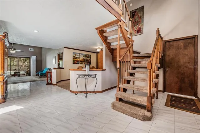 a view of a livingroom with furniture and staircase