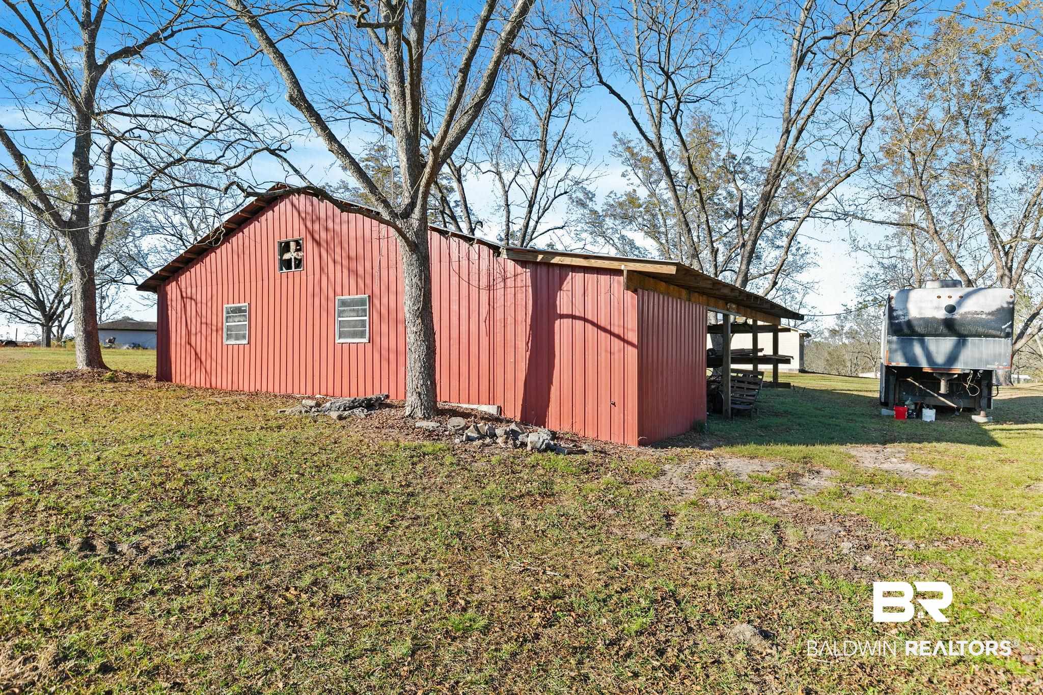21267 Loop Road Andalusia, AL 36421 - Photo 65 of 72 View of property exterior with a yard, an outbuilding, and board and batten siding