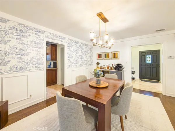 a view of a dining room with furniture and chandelier