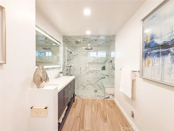 a bathroom with a double vanity sink a mirror and shower