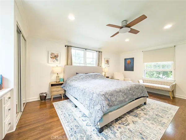 a spacious bedroom with a large bed and a chandelier
