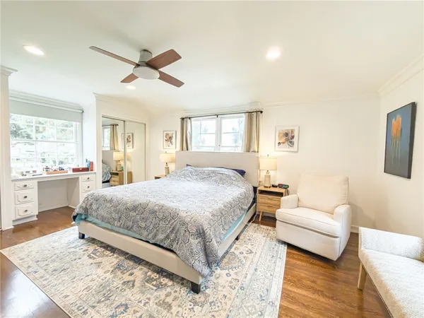 a spacious bedroom with a bed and a couch