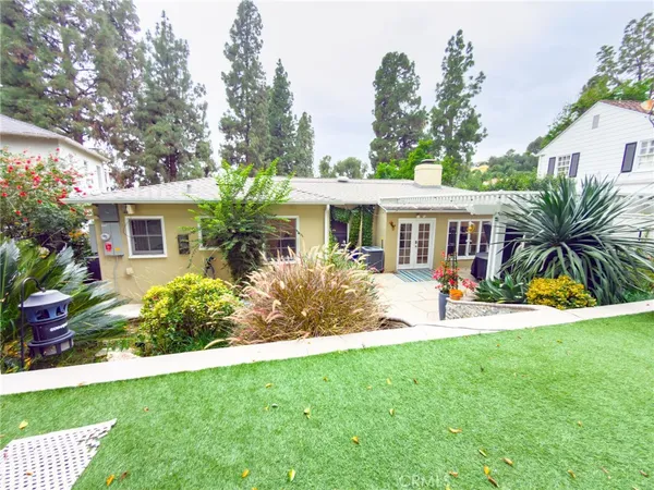 a front view of a house with yard and green space