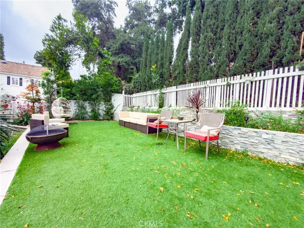 a backyard of a house with table and chairs