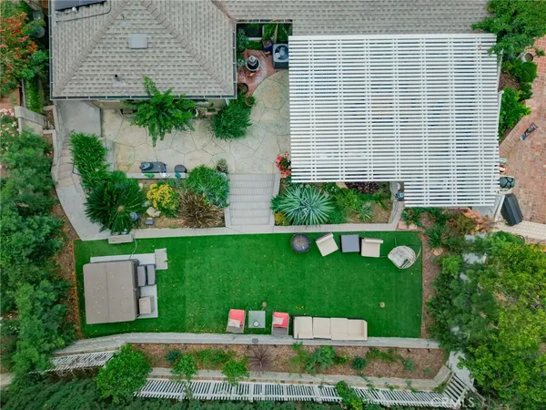 a view of a house with a yard and potted plants