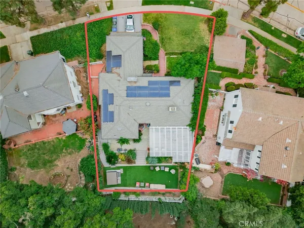 an aerial view of a house with a garden and plants