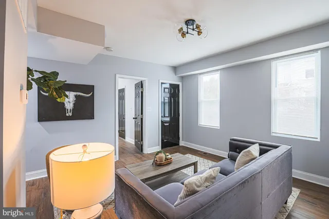 a kitchen with stainless steel appliances granite countertop a refrigerator a stove a sink dishwasher and white cabinets with wooden floor