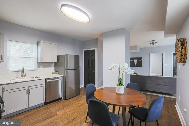 a kitchen with stainless steel appliances granite countertop a refrigerator stove top oven a sink and dishwasher