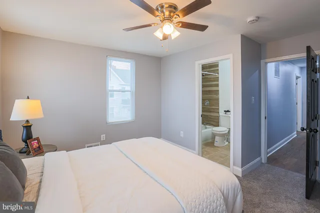 a bedroom with a bed and a lamp