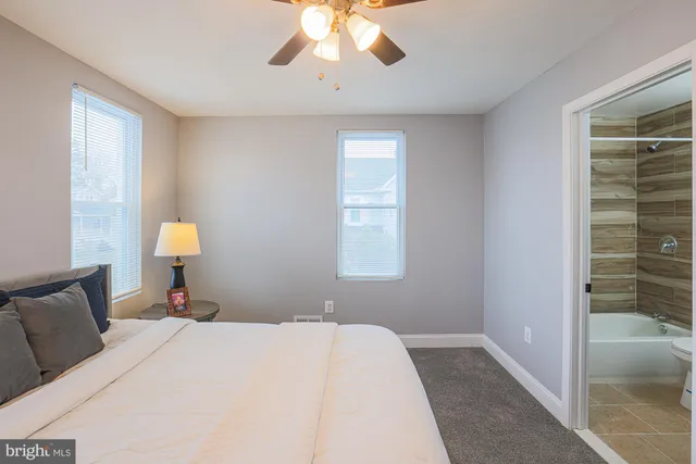 a bedroom with a bed and a lamp on table