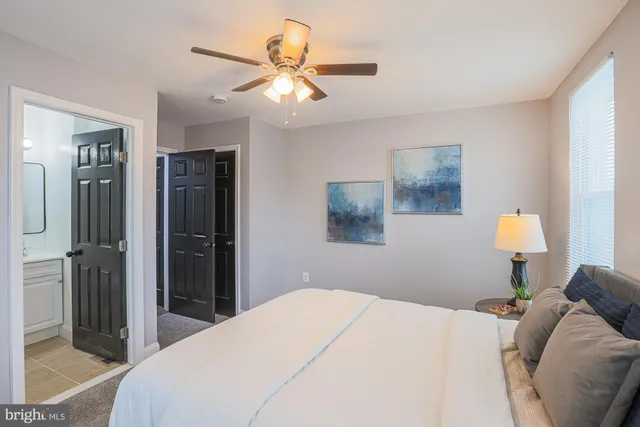 a bed sitting in a bedroom next to a lamp