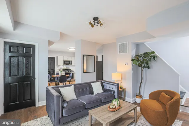 a living room with furniture and a potted plant