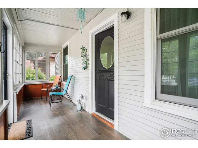 a balcony with furniture and wooden floor