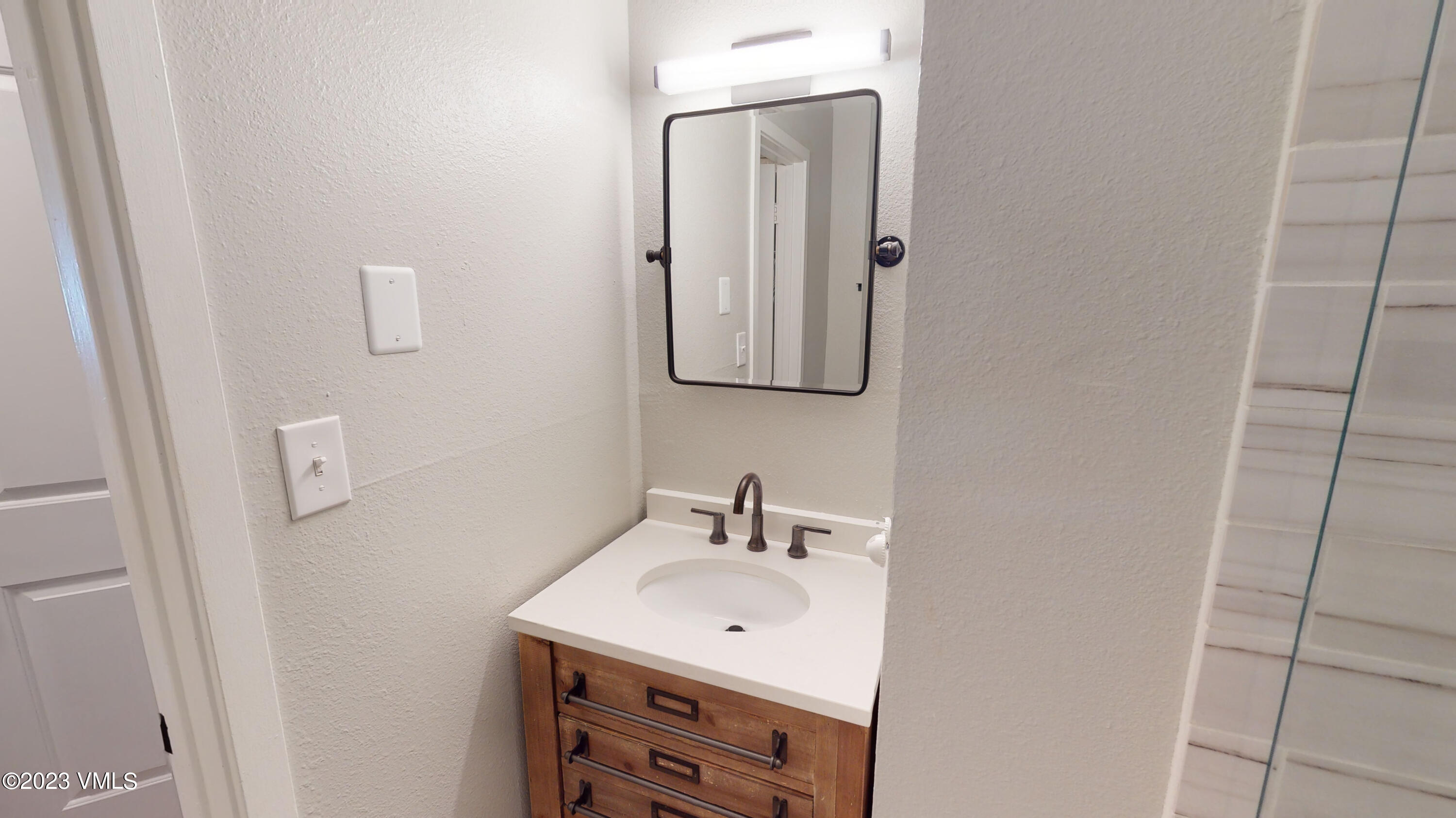 3971 Bighorn, Unit 7N Vail, CO 81657 - Photo 11 of 19 a bathroom with a sink and mirror