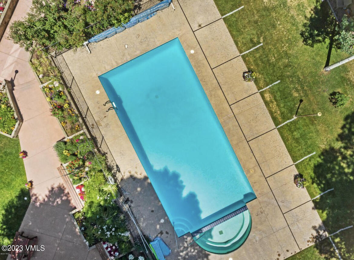 3971 Bighorn, Unit 7N Vail, CO 81657 - Photo 14 of 19 a view of a backyard with plants and a lake view