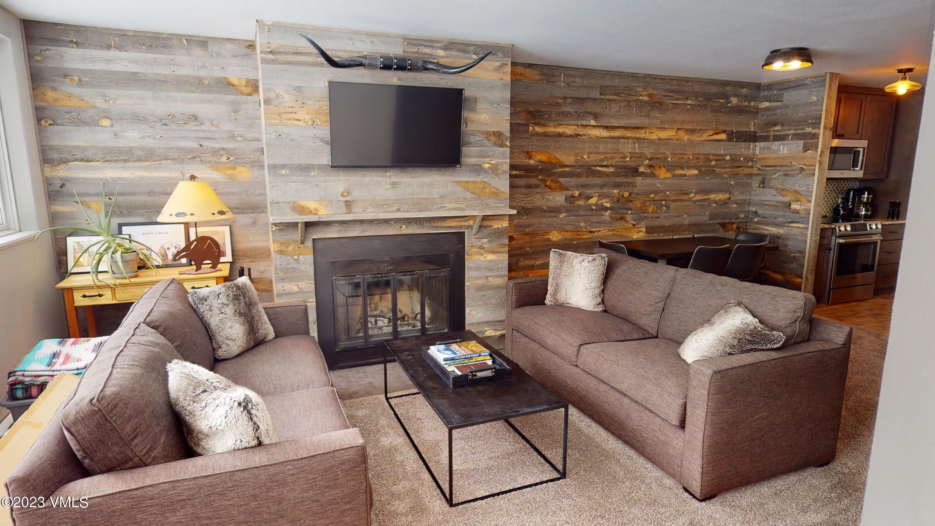 3971 Bighorn, Unit 7N Vail, CO 81657 - Photo 2 of 19 a living room with furniture a fireplace and a flat screen tv
