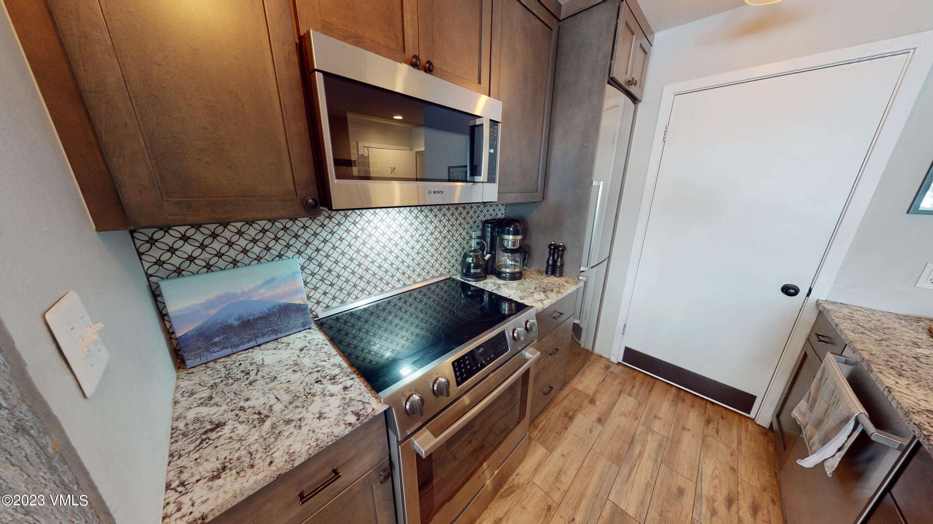 3971 Bighorn, Unit 7N Vail, CO 81657 - Photo 3 of 19 a kitchen with granite countertop a stove and a microwave