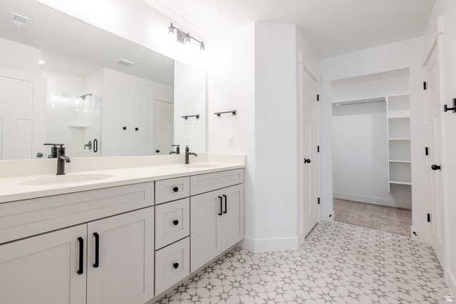 4775 Olive Avenue, Unit 412 Mapleton, UT 84664 - Photo 12 of 19 Bathroom with double vanity, a shower stall, a spacious closet, and light floors
