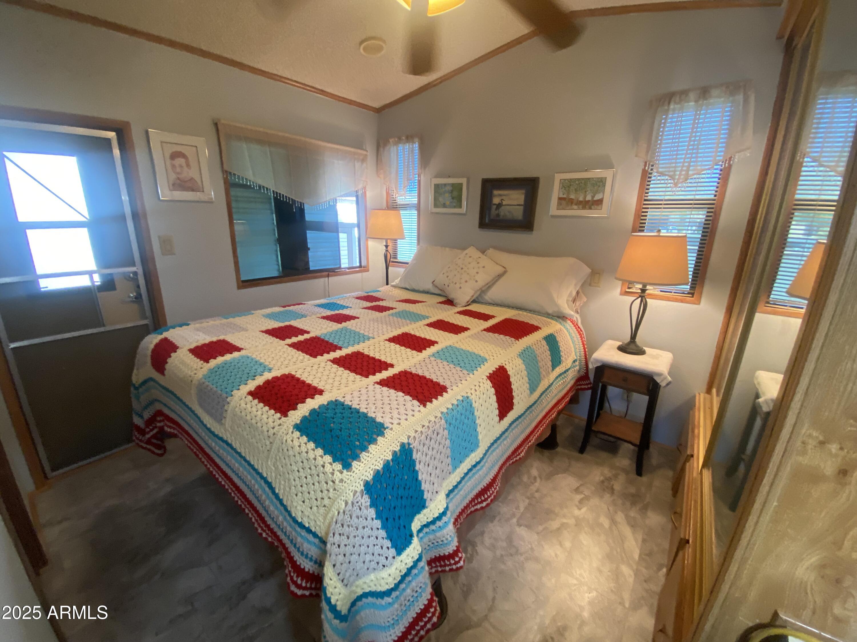 1177 Kiowa Circle Apache Junction, AZ 85119 - Photo 15 of 24 a bedroom with a bed a lamp and a mirror