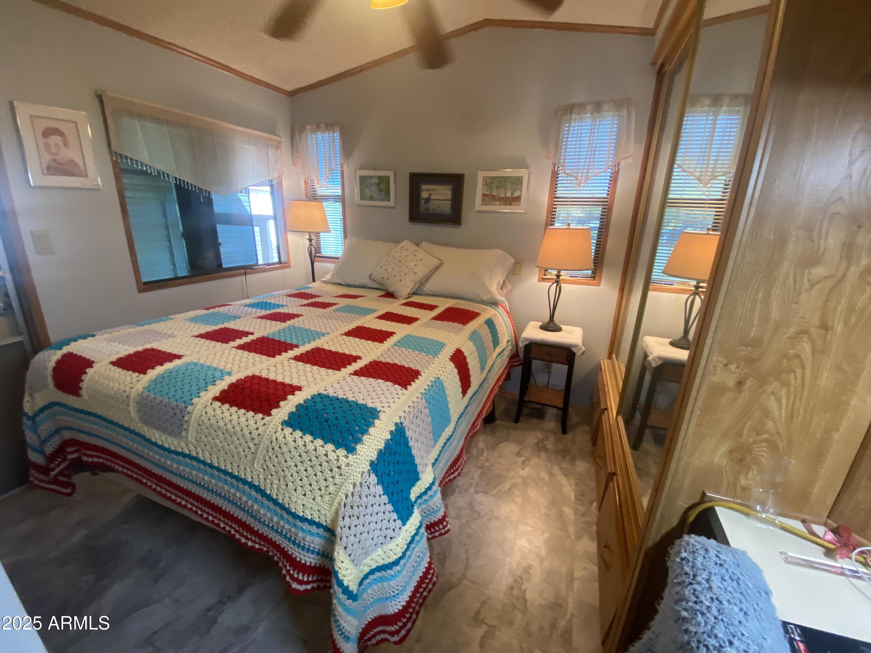 1177 Kiowa Circle Apache Junction, AZ 85119 - Photo 16 of 24 a bedroom with a bed and wooden floor