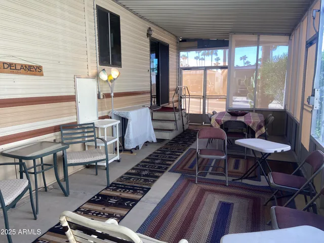 a living room with furniture and a floor to ceiling window