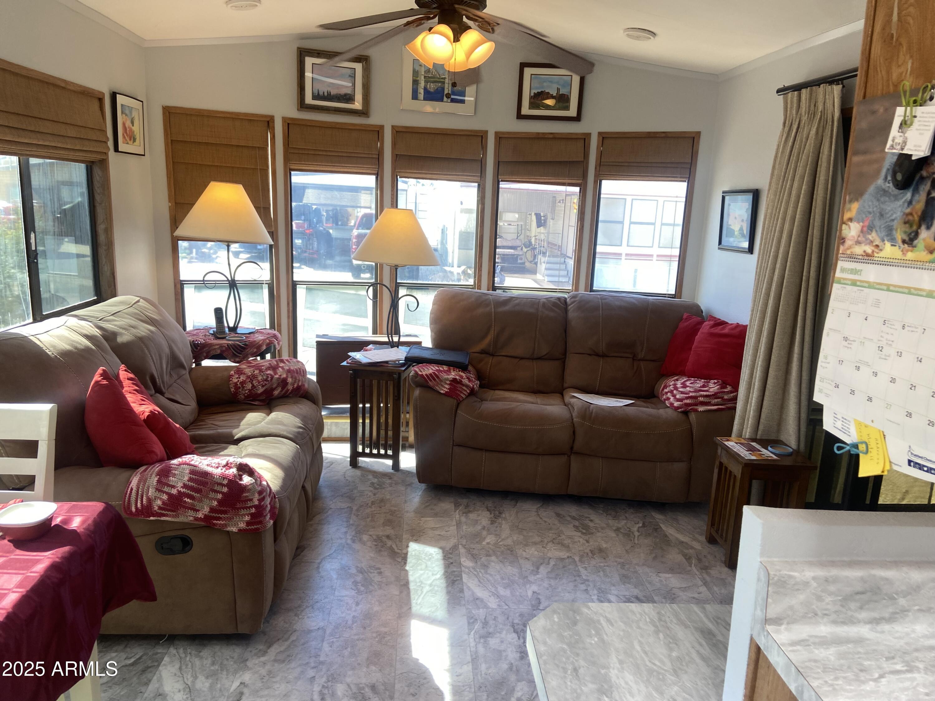 1177 Kiowa Circle Apache Junction, AZ 85119 - Photo 3 of 24 a living room with furniture a window and a chandelier