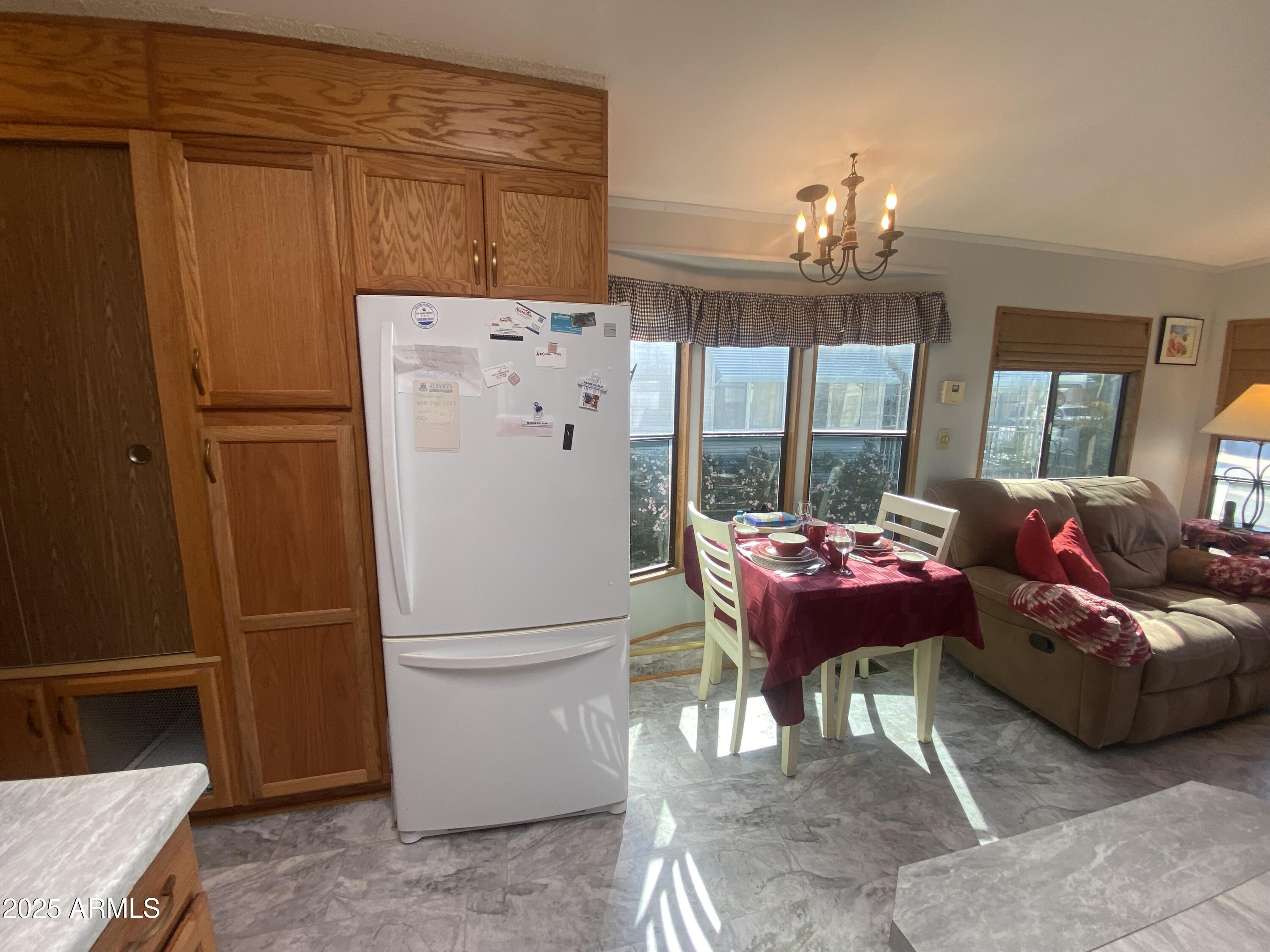 1177 Kiowa Circle Apache Junction, AZ 85119 - Photo 10 of 24 a bed room with a bed and a chandelier