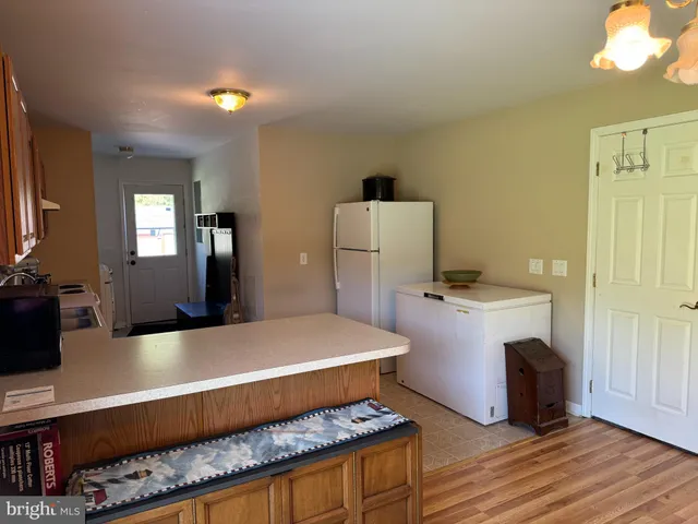 a room with pool table and windows