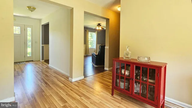 a view of a hallway view with wooden floor and staircase