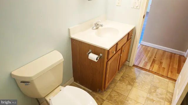 a white toilet sitting next to a bathroom sink