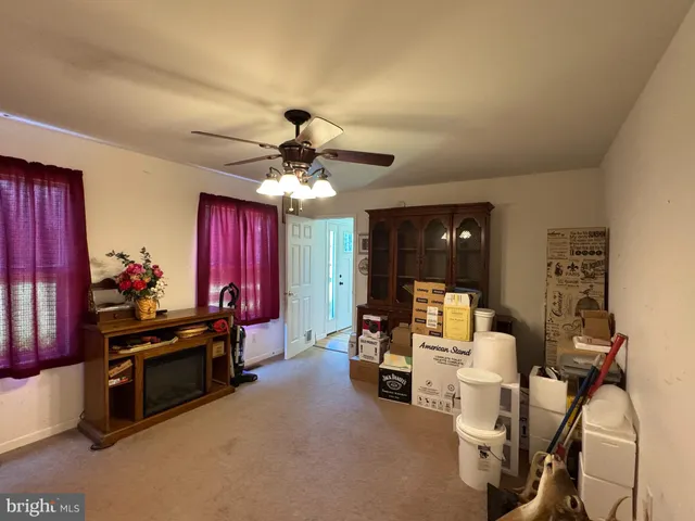 a view of a livingroom with furniture and a ceiling fan