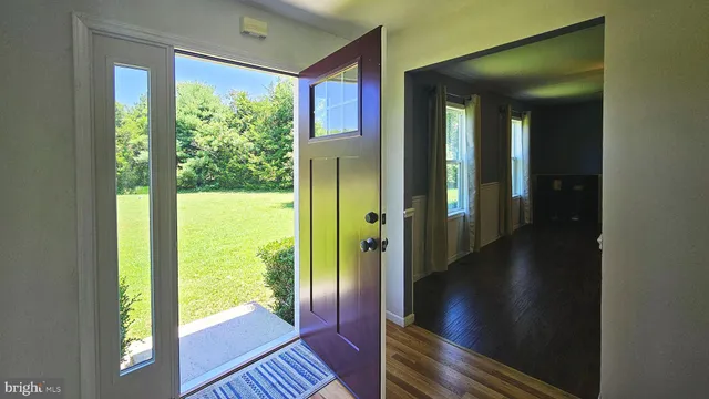 a view of a hallway with furniture and floor to ceiling window