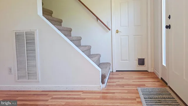 a view of entryway and hall with wooden floor