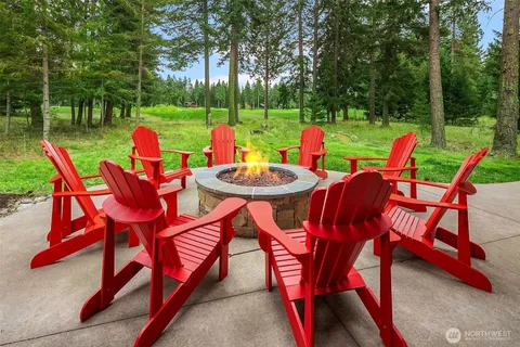 a view of a chairs and table in backyard