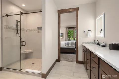 a bathroom with a shower sink and mirror