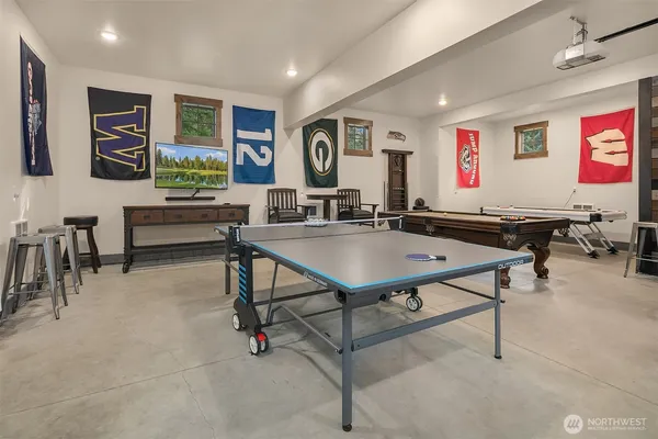 a living room with furniture pool table and a flat screen tv