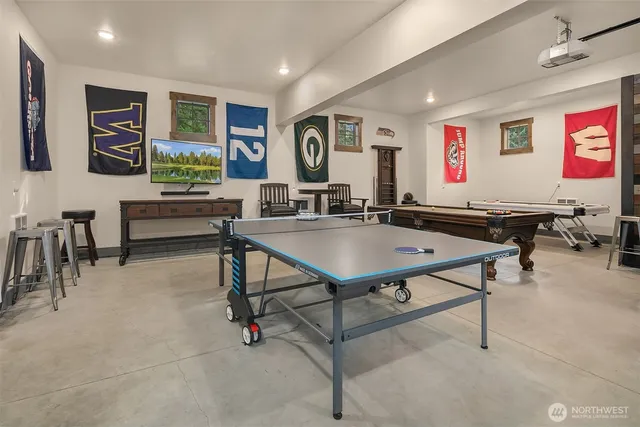 a living room with furniture pool table and a flat screen tv