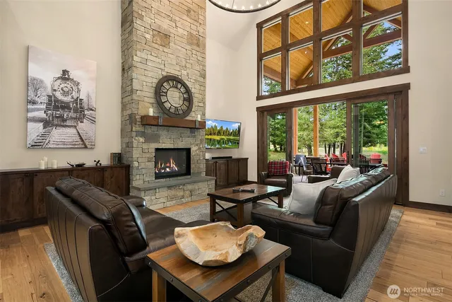 a living room with furniture a fireplace and a large window