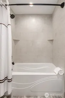 a bathroom with a shower and a bathtub