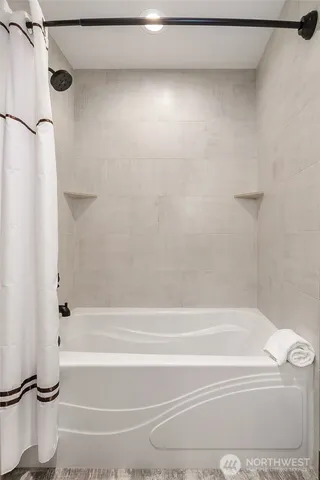 a bathroom with a shower and a bathtub