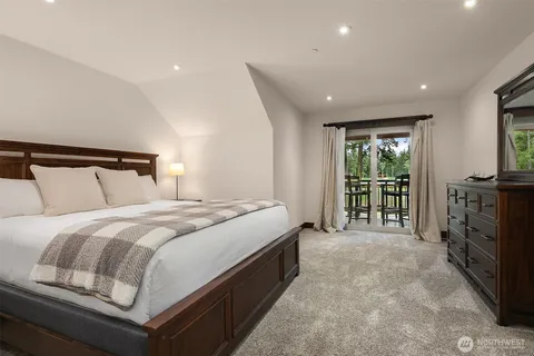 a spacious bedroom with a bed and a large window