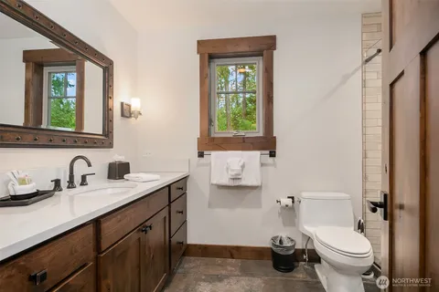 a bathroom with a toilet sink and mirror