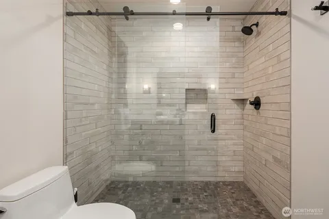 a bathroom with a toilet and a shower