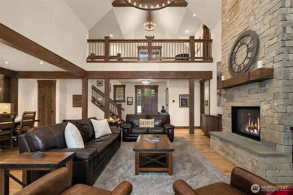 a living room with furniture a fireplace and a large window