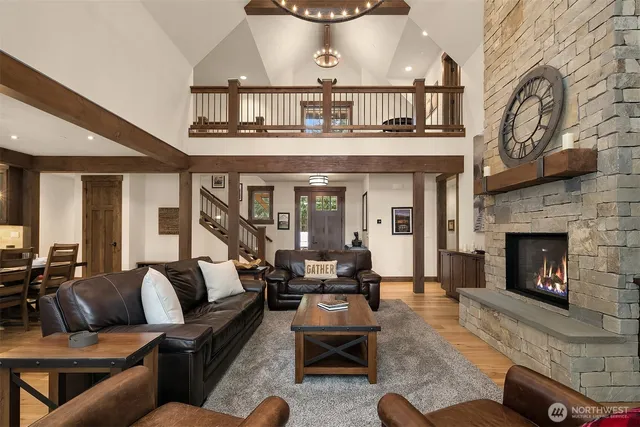 a living room with furniture a fireplace and a large window