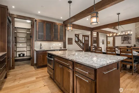 a kitchen with a stove a counter space a sink and cabinets
