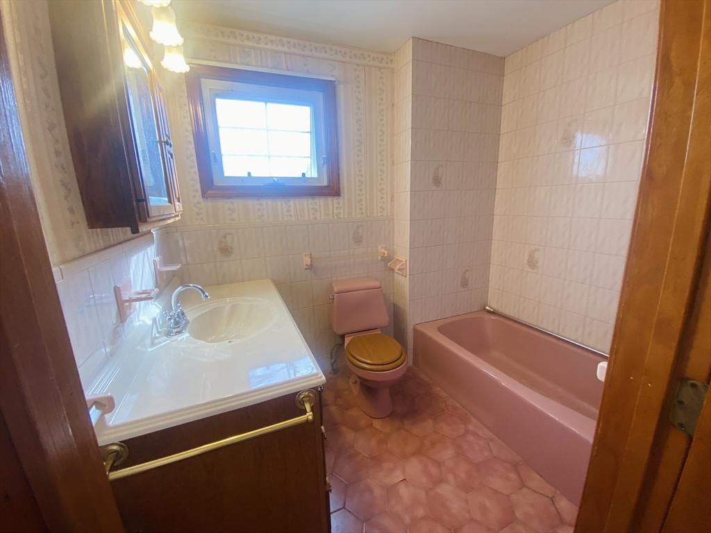 7 River St Place Lynn, MA 01905 - Photo 13 of 16 a bathroom with a sink a toilet and shower