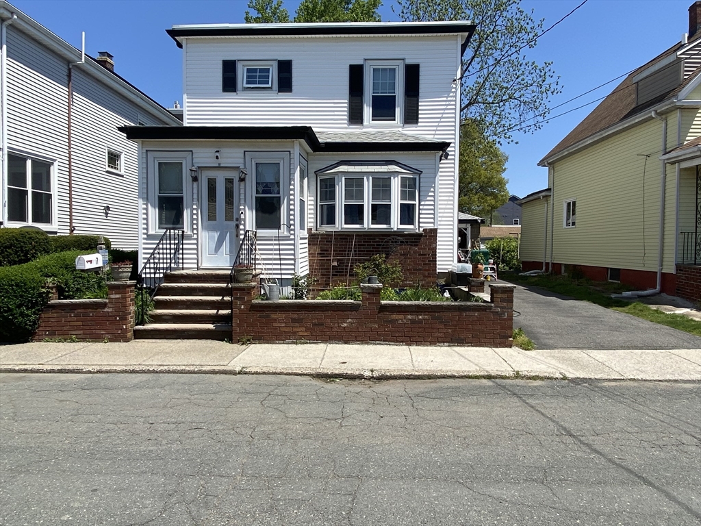 7 River St Place Lynn, MA 01905 - Photo 2 of 16 a front view of a house with a yard