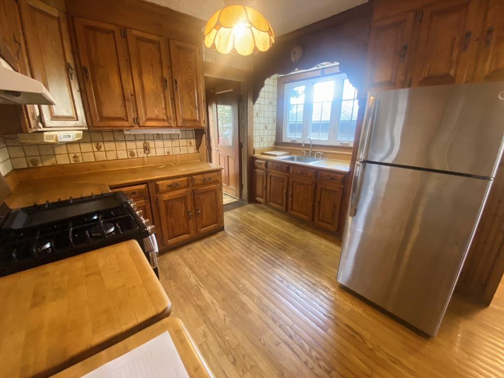 7 River St Place Lynn, MA 01905 - Photo 5 of 16 a kitchen with a refrigerator and a stove