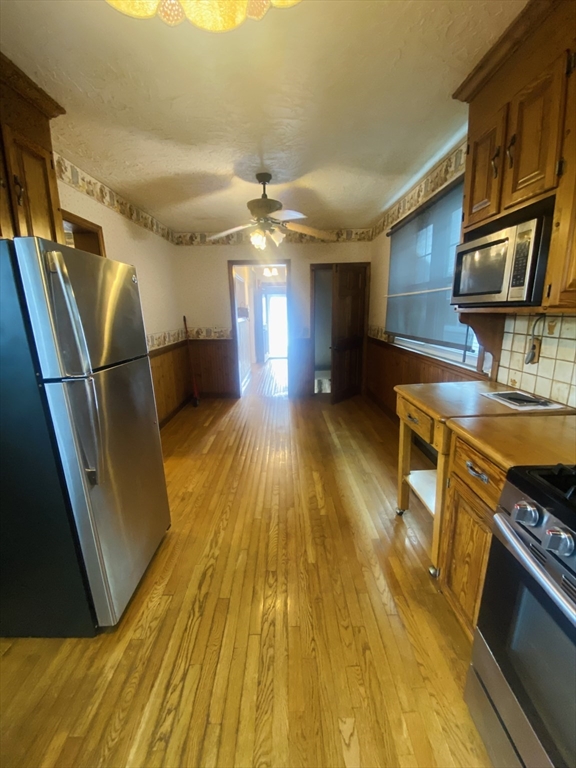 7 River St Place Lynn, MA 01905 - Photo 6 of 16 a view of kitchen with cabinets and wooden floor